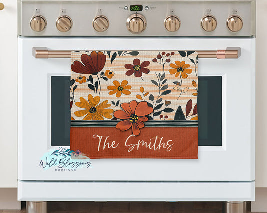 Floral towel with 'The Smiths' text on a white stove