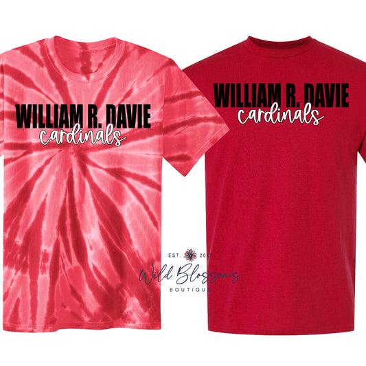 Two custom t-shirts displayed side-by-side on a white background. The left shirt is a pink and red spiral tie-dye with black and white text reading 'WILLIAM R.