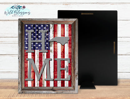A rectangular sign featuring the American flag with the text 'Home Me' in a stylized font, indicating a patriotic theme, presented in two styles: framed and unframed.